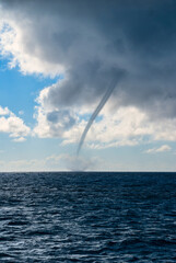 Portrait view of water spout on the ocean