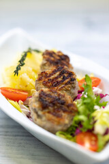 minced veal steaks with mashed potatoes and salad