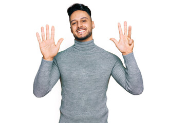 Young arab man wearing casual clothes showing and pointing up with fingers number nine while...