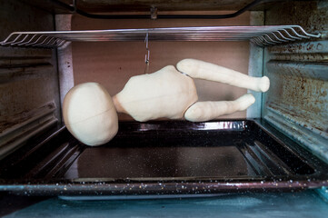 Production of textile dolls. Tinted blanks of toys are dried in the oven.