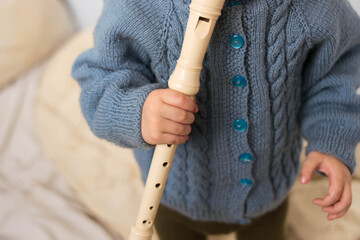 Flute. Block flute. The child plays the pipe. Music. The child is making music. Art. Musical instruments. © Lisa Chip