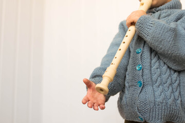 Flute. Block flute. The child plays the pipe. Music. The child is making music. Art. Musical instruments. © Lisa Chip