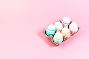 Colorful Easter eggs on a pink background. Copy space. Celebrating Easter