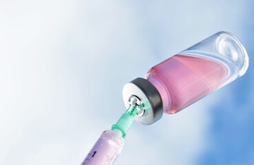 syringe with a needle in a vial of medicine
  on the background of the blue sky 