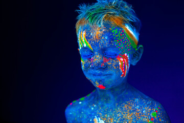 Baby boy smiling posing in UV light