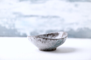 Traditional ceramic bowl on bright background. Copy space.	