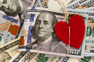 bundle of American one hundred dollars with red heart tied natural rope with bow
