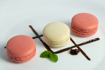 Colorful Macaroons in a beatiful plate with decoration in chocolate