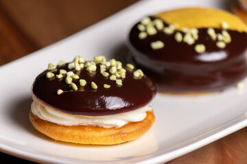 Bouche. Homemade stuffed desserts with pistachio crunches on top.
