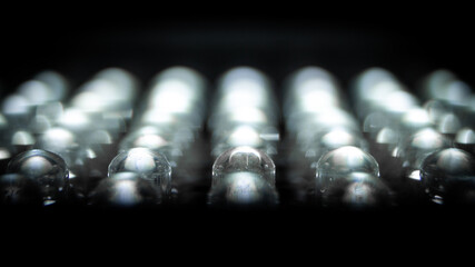 Moody, Shadow Extreme Close-Up of a Row of Small, Lit LED Light Bulbs