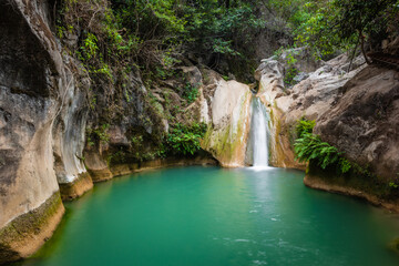 Obraz premium Waterfall in the middle of the jungle, small stream with crystal clear waters, in Taxco, Guerrero, Mexico
