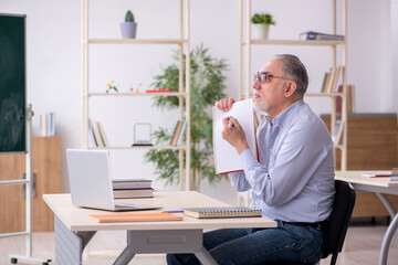 Old male teacher in the classroom