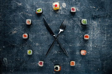 sushi clock with fork and knife, concept of time to eat