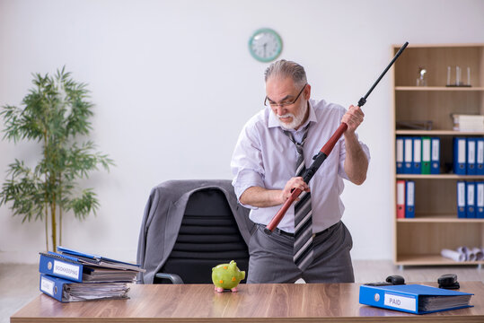 Old male employee holding rifle in budget planning concept