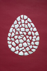 egg concept easter, eggshell on a red background, pattern, mosaic, minimalism