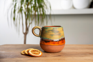 colorful handmade ceramic coffee cup on wooden table