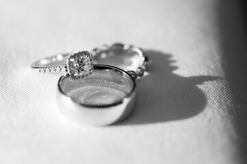 Wedding Rings and Diamonds on White Table