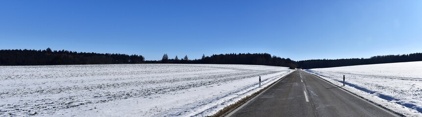 Way and road into the winter landscape cold season wonderful panorama. Cold season with snow and blue sky.