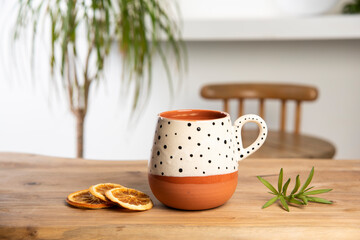 colorful handmade ceramic coffee cup on wooden table
