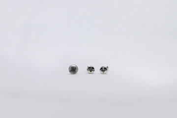 Photo shoot of screws on white background. Variety of screws. Product photos.