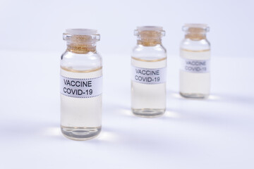 three vials of coronavirus vaccine stand diagonally