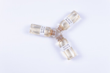 covid-19 vaccine vials lie on white isolated background
