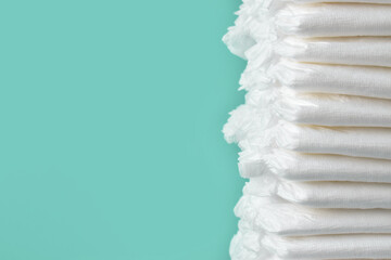 A stack of diapers on a blue background. Children's hygiene. Newborn care.