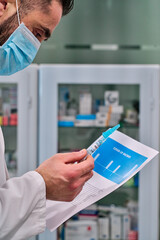 man in facemask with report and syringe