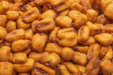 Fried, salted corn grains close-up. Texture of corn nuts. An organic beer snack or savory snack. 