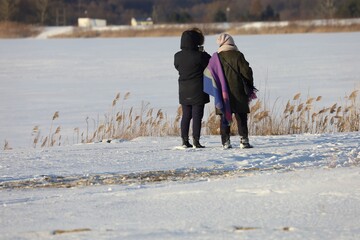people are walking on the snowy beach