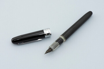 Black signature pen on the gray background.