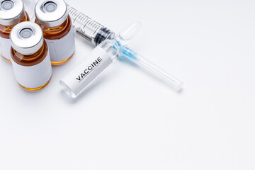 vaccination and vaccine concept. drugs and syringe on white desk. pharmacology research conceptual