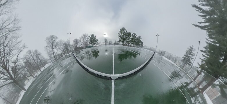 Panorama of an Ice-Covered Tennis Court in the Winter on an Overcast Day