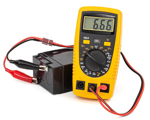 Testing an acid rechargeable battery with a measuring instrument isolated on white background