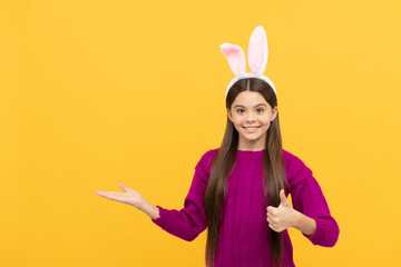 happy easter teen girl in funny bunny ears presenting product, copy space, happy easter