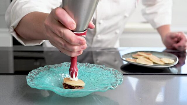 Professional chef holding a foam siphon in a restaurant kitchen. High quality 4k footage.