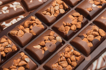 Chocolate bar with nuts close-up. White and milk chocolate. Chocolate texture.