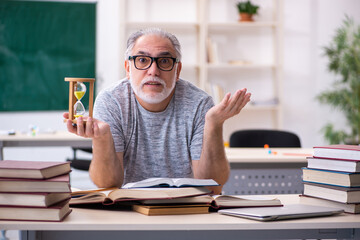 Old male student in time management concept