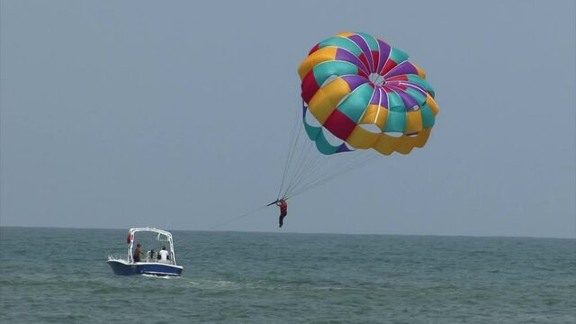 Tourists parasailing at Famous Playa De Bocagrande (Bocagrande beach) in Cartagena, Colombia.