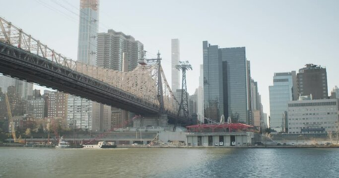 A panning shot of the Ed Koch Bridge over the East River, taken from Roosevelt Island