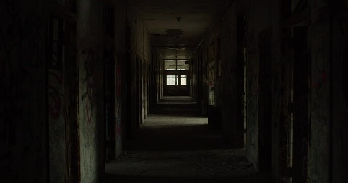 Walkthrough shot of an vandalized hallway in an abandoned building