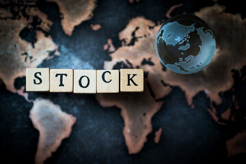 Wooden cube block showing ”STOCK” wording