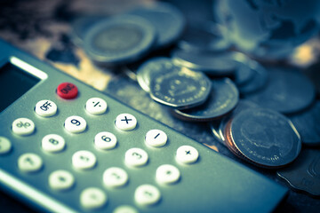 INVESTMENT concept.  Pile of coins with calculator