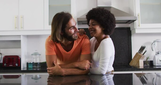 Portrait of mixed race couple smiling in the kitchen at home