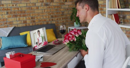 Diverse couple on a valentines date video call woman on laptop screen holding marry me sign - Powered by Adobe