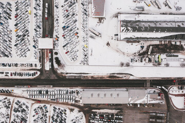 Aerial view of the trucks unloading at the logistic center. Drone photography.