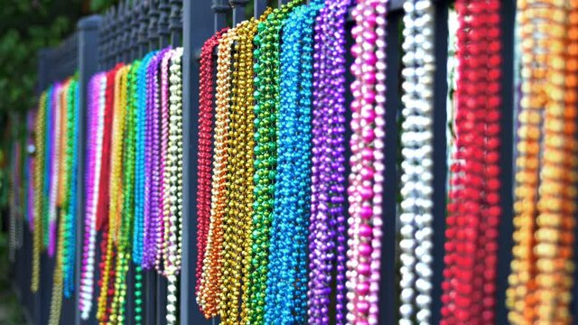 Colorful Mardi Gras Beads Hanging on Iron Fence New Orleans
