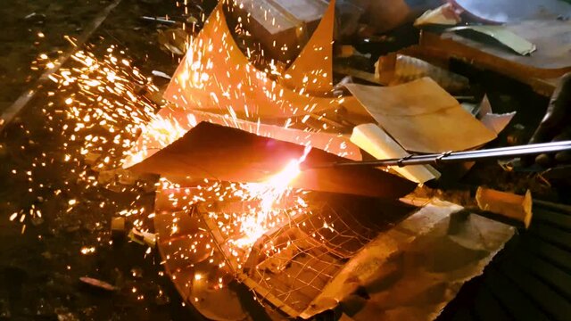 Gas cutter, cutting the metal scrap at scrapyard. Slow motion. Close up.