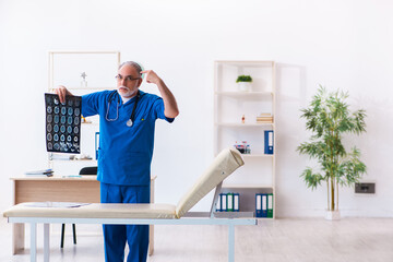 Old male doctor radiologist working in the hospital