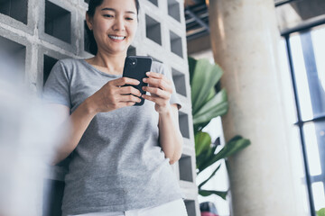 Fototapeta premium using cell phone hand holding mobile texting message contact us.chatting,search internet information in office.technology device communication connecting